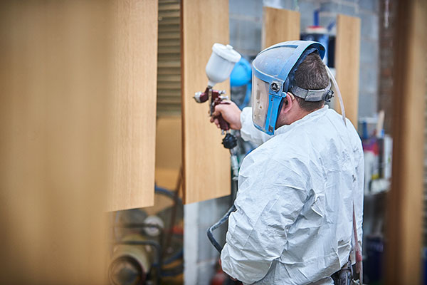 Man spraying wood